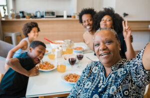 Portrait of african american multigenerational family taking a selfie together while having dinner at home. Family and lifestyle concept.
